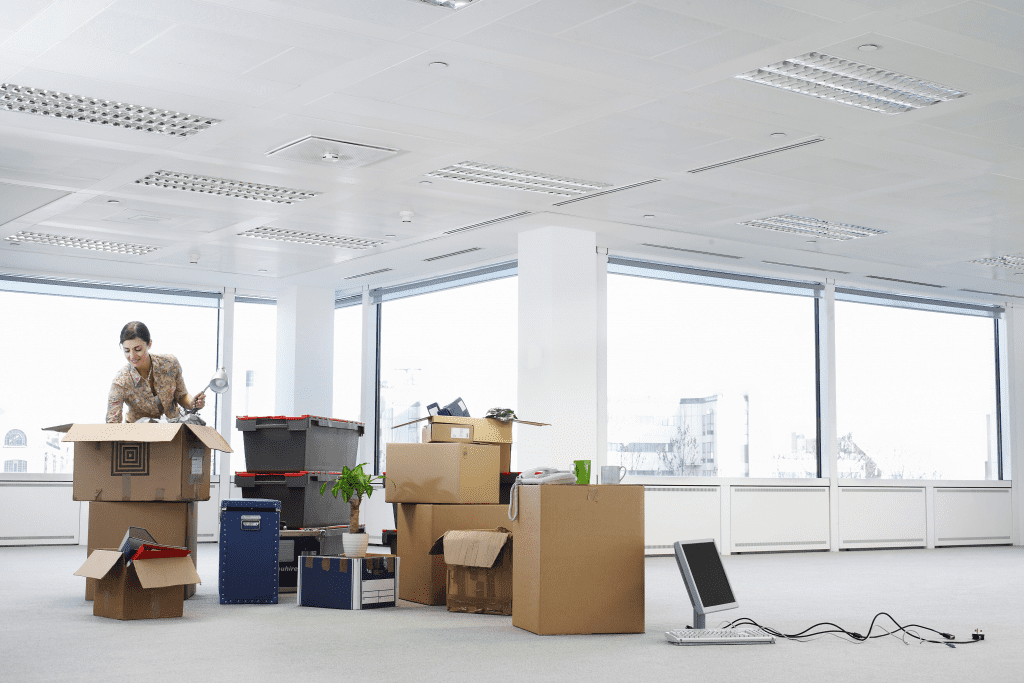 woman unpacking boxes in new office
