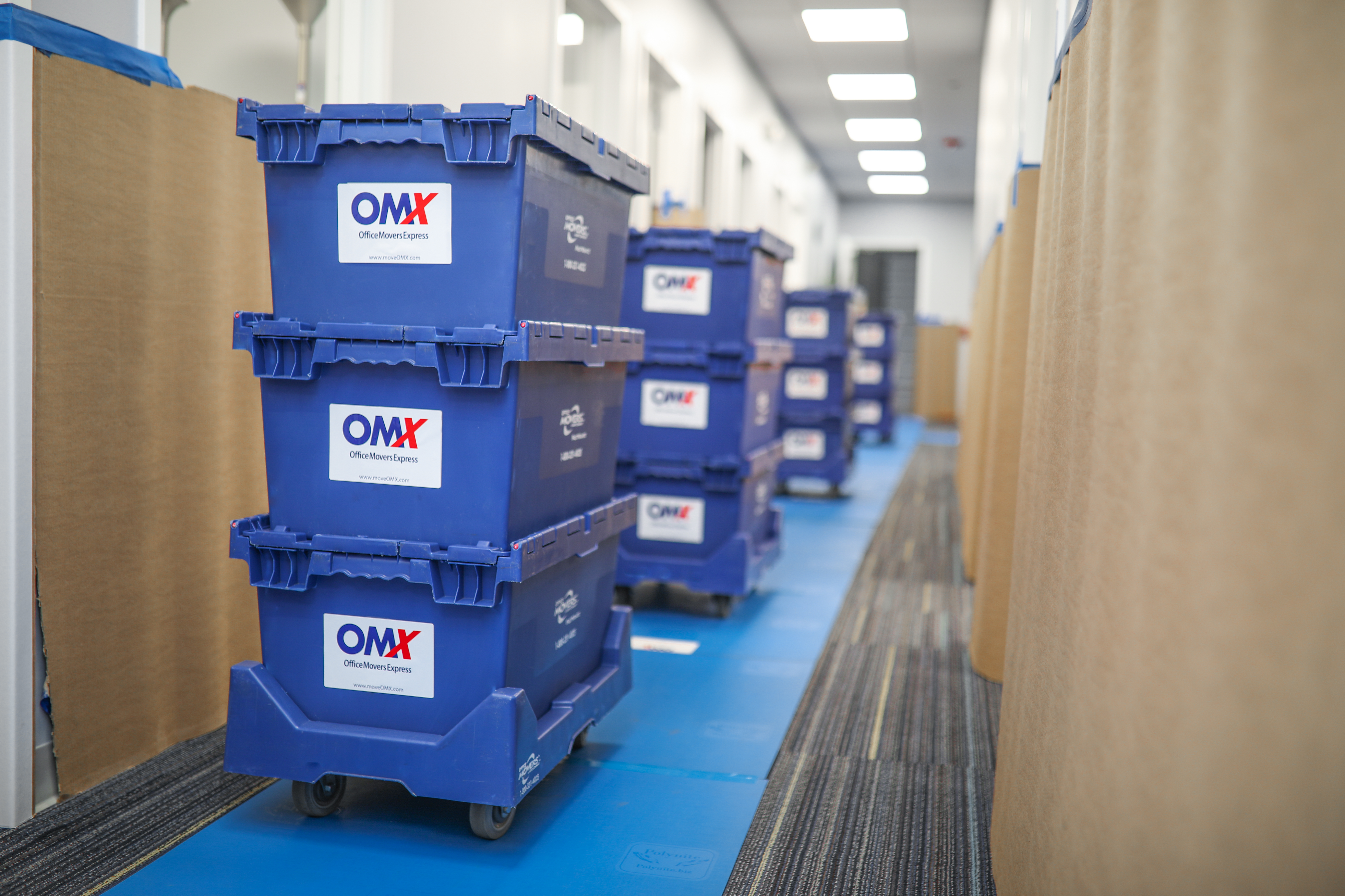 OMX moving crates in hallway